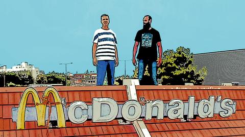 Zwei Männer stehen auf dem Dach einer geschlossenen McDonalds-Filiale, Bild im Comic-Style.