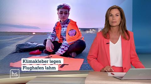 hessenschau-Moderatorin Claudia Schick und die Schlagzeile: Klimakleber legen Flughafen lahm