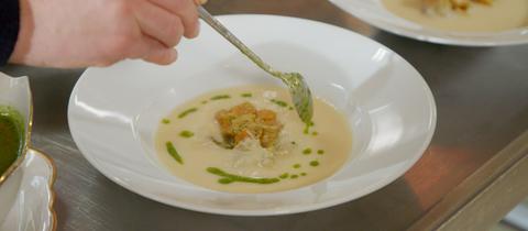 Petersilienwurzelsuppe mit Saiblingeinlage und Petersilienöl.