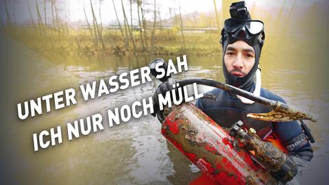 Noah von den Lahntauchern mit einem Feuerlöscher in der Hand, den er aus dem Fluss geborgen hat. 