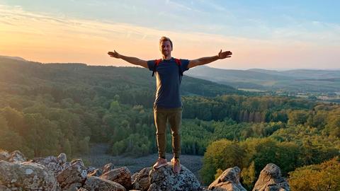 Daniel Aßmann genießt den Sonnenuntergang in der Rhön